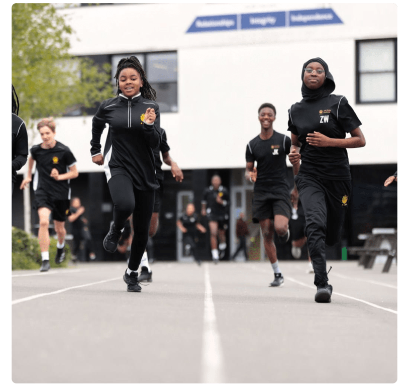 School children running on a running track at school